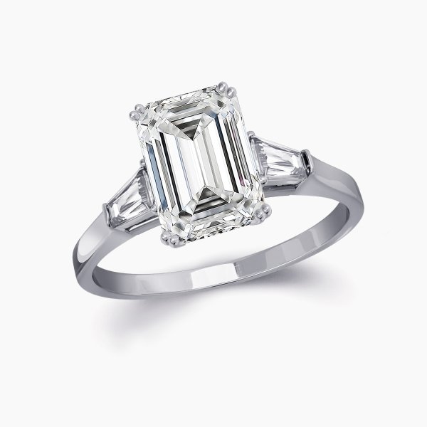 Our Bowery Setting is a three stone engagement ring shown here with an emerald cut diamond with two baguettes
