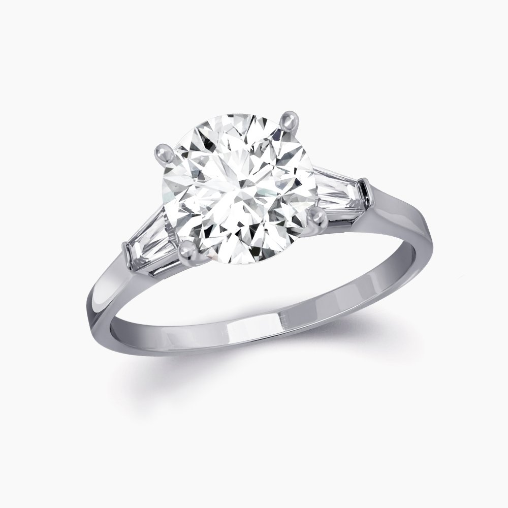 Our Bowery Setting is a three stone engagement ring shown here with a round brilliant diamond with two baguettes