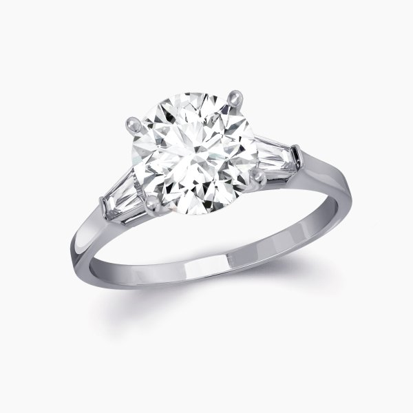 Our Bowery Setting is a three stone engagement ring shown here with a round brilliant diamond with two baguettes