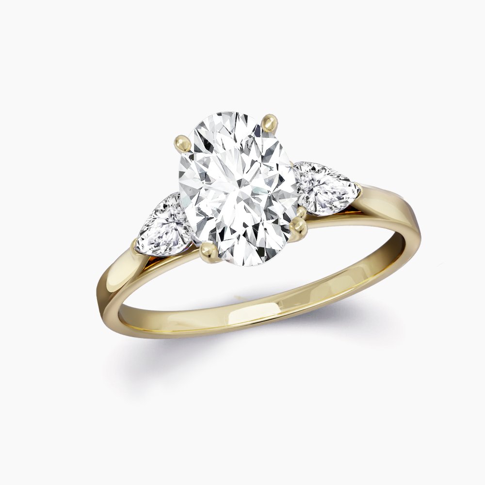 Our Martel Setting is a three stone engagement ring shown here with an oval cut diamond with two pears